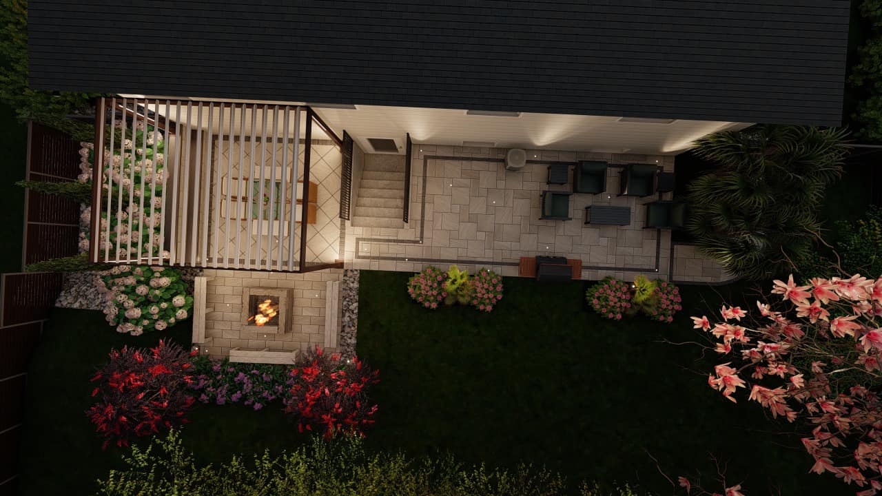 Backyard with a tiled patio, pergola, outdoor furniture, fire pit, and colorful landscaping. Evening lighting creates a cozy ambiance.