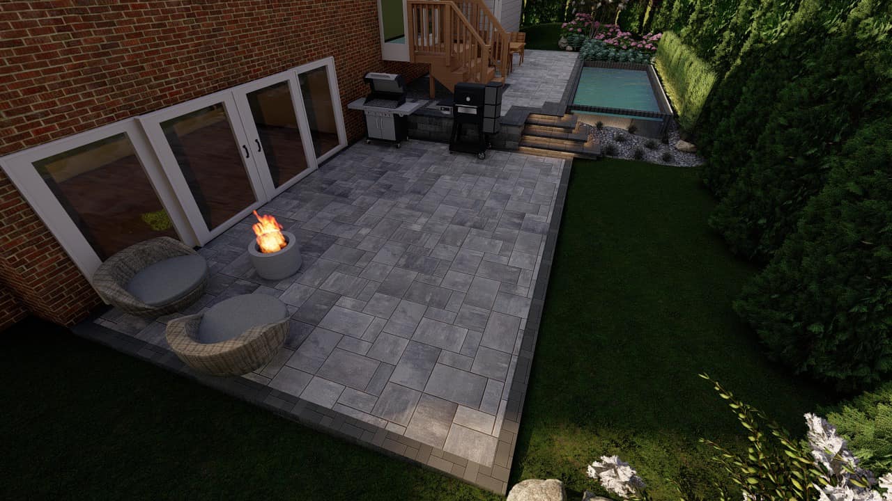 Brick patio with modern seating and a fire pit, leading up to a wooden deck and small pool, surrounded by greenery.