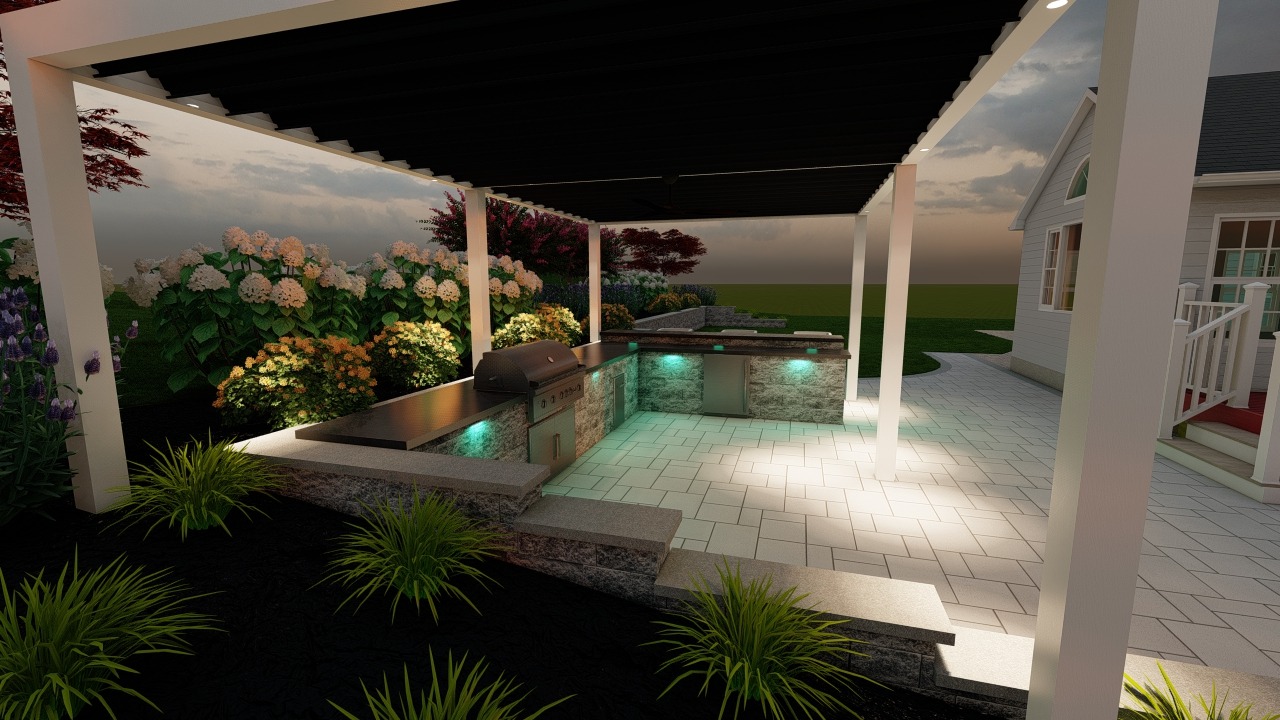 Outdoor kitchen under a pergola, featuring illuminated countertops and a grill, surrounded by lush garden landscaping near a house at sunset.