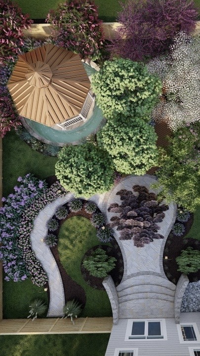 Aerial view of a landscaped garden with paths, lush greenery, flowering plants, and a small gazebo with a conical roof.
