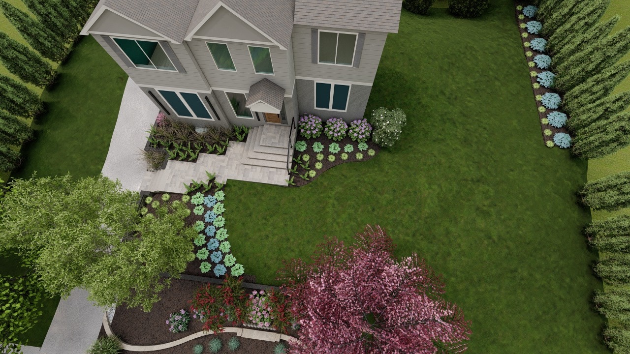 Aerial view of a modern house with a landscaped garden, featuring lush greenery, vibrant flowers, and a driveway.