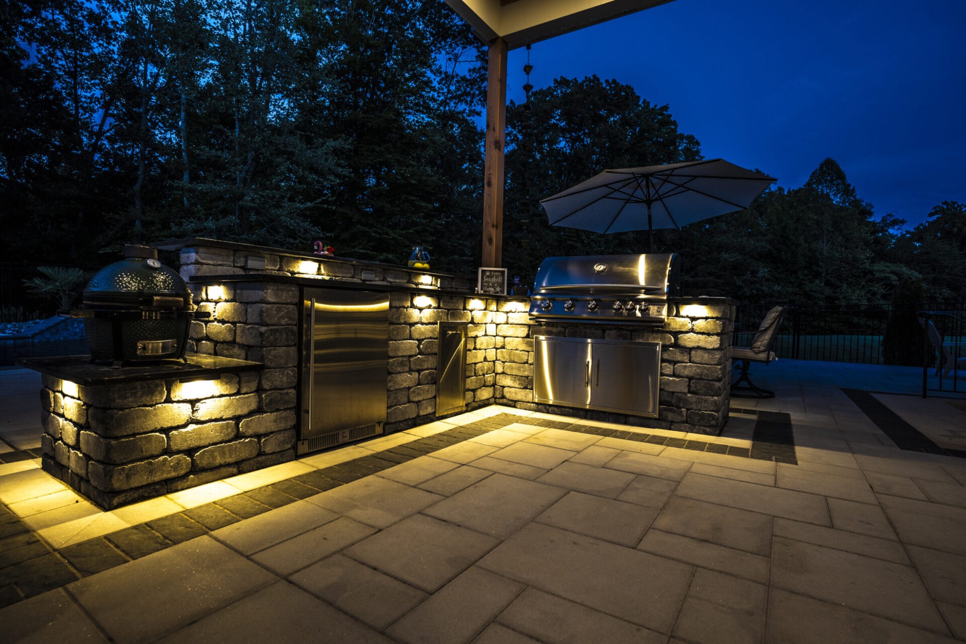 An outdoor kitchen with ambient lighting that enhances the atmosphere of the space.