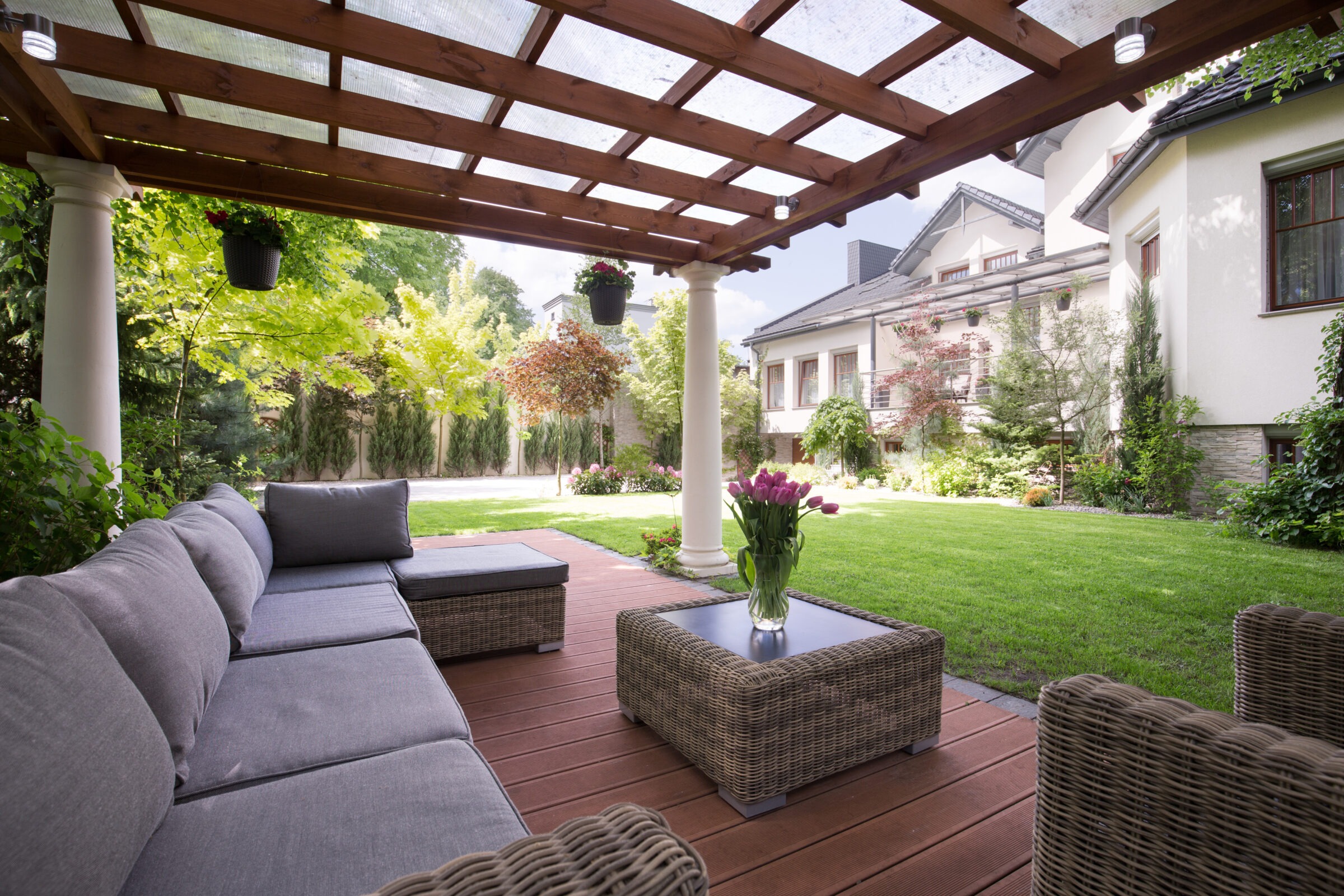 An outdoor patio with a pergola and a couch.